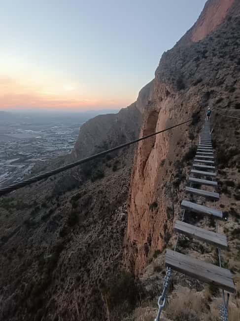 Elda: El Bolón via ferrata with zipline and abseiling - Climbing the first vertical wall