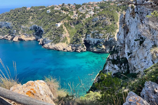 Kayak Paradise: Cala Portixol Snorkel, Cave & Cliff Jumping Tour - Cap Negre, a wall of rock above the kayak