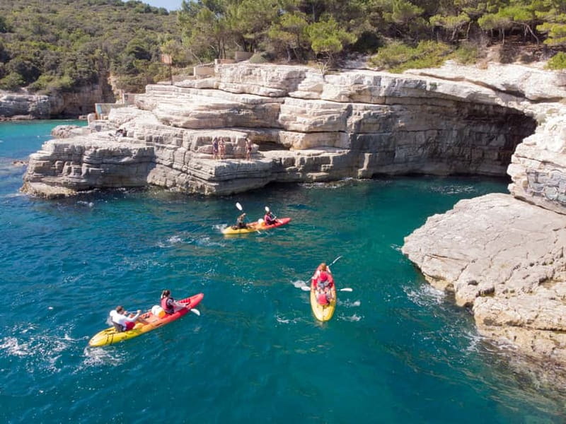 Pula: Sea Adventure – Boat, Kayak, Snorkeling & Cliff Jumps - Kayaking beneath Muzil’s high cliffs